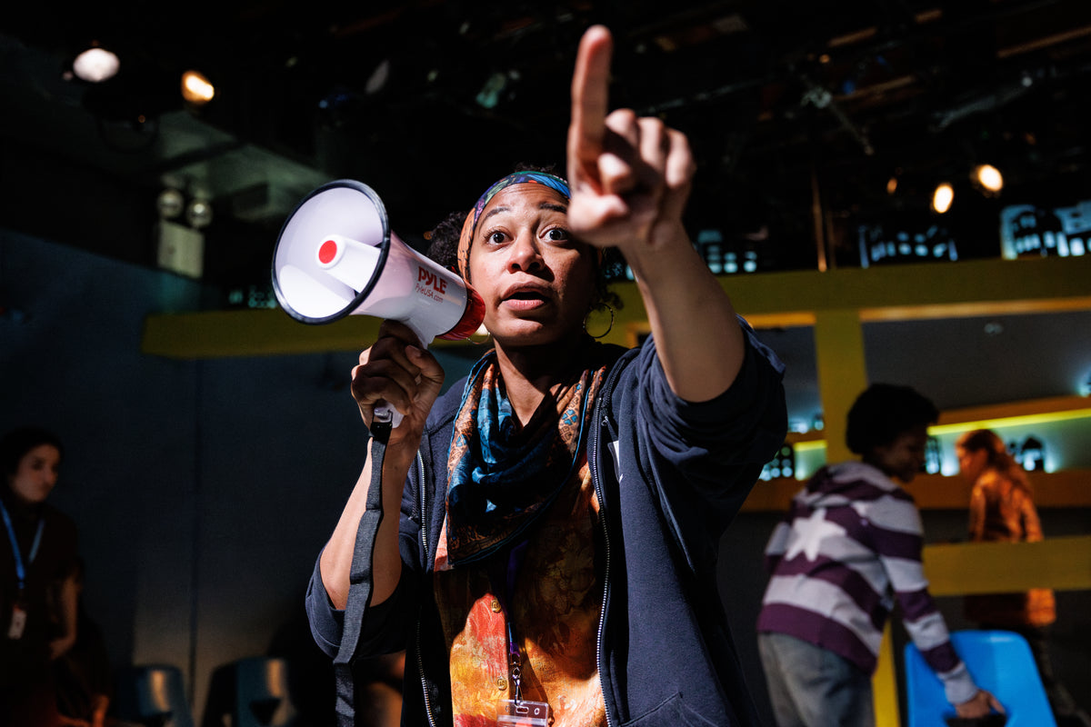Titans: Eliysheba organizes with a bullhorn.